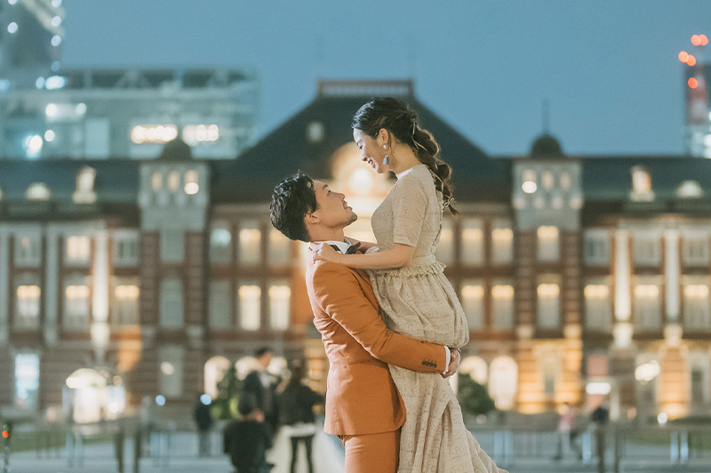 A couple in front of Tokyo Station at dusk, photographed by La Vie Factory