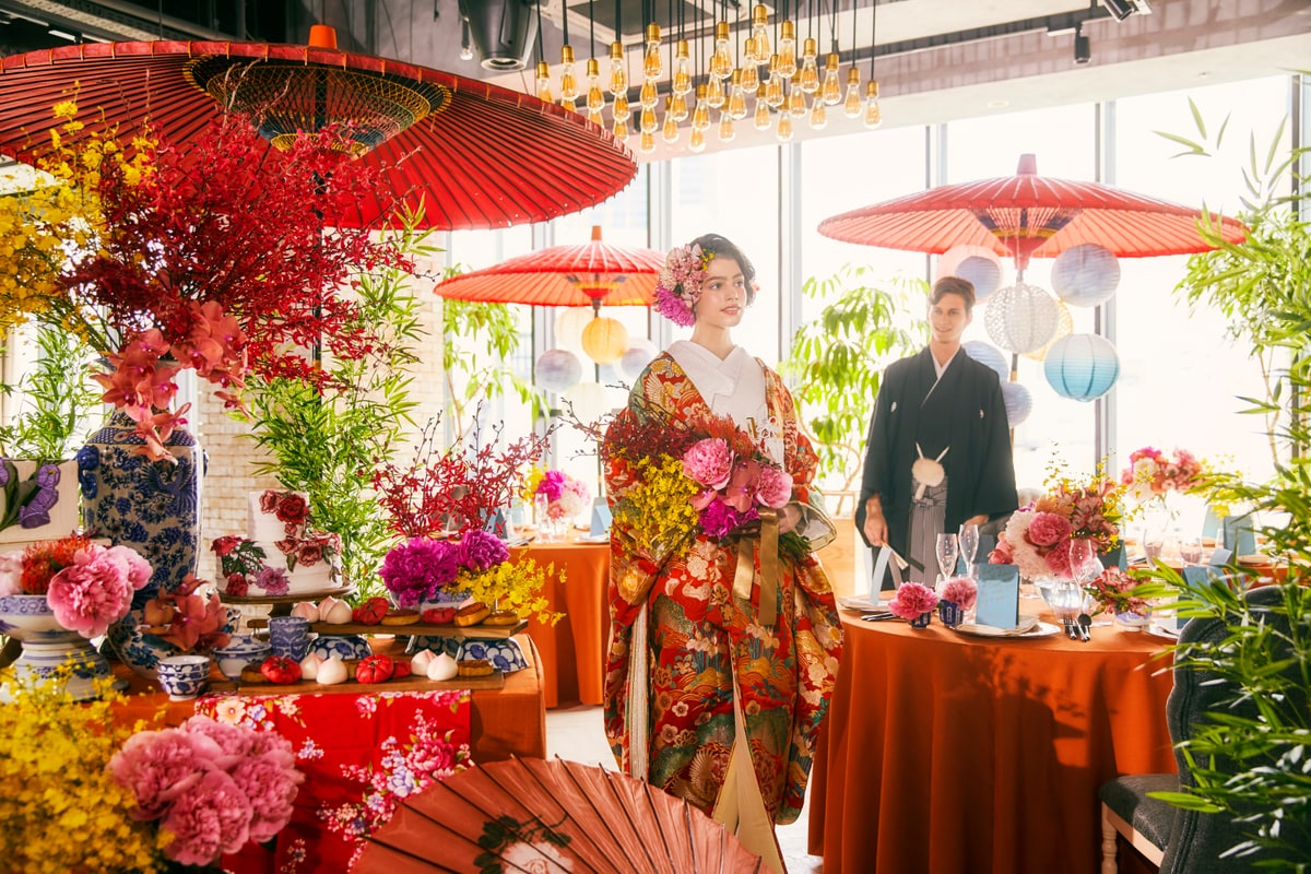 A bride in a colorful kimono in a Japanese-inspired reception setting