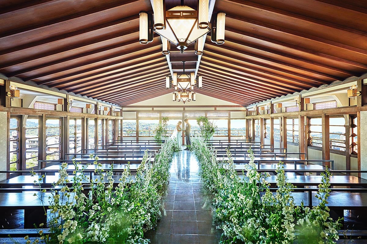 A timber chapel with a flower-lined aisle overlooking Kyoto