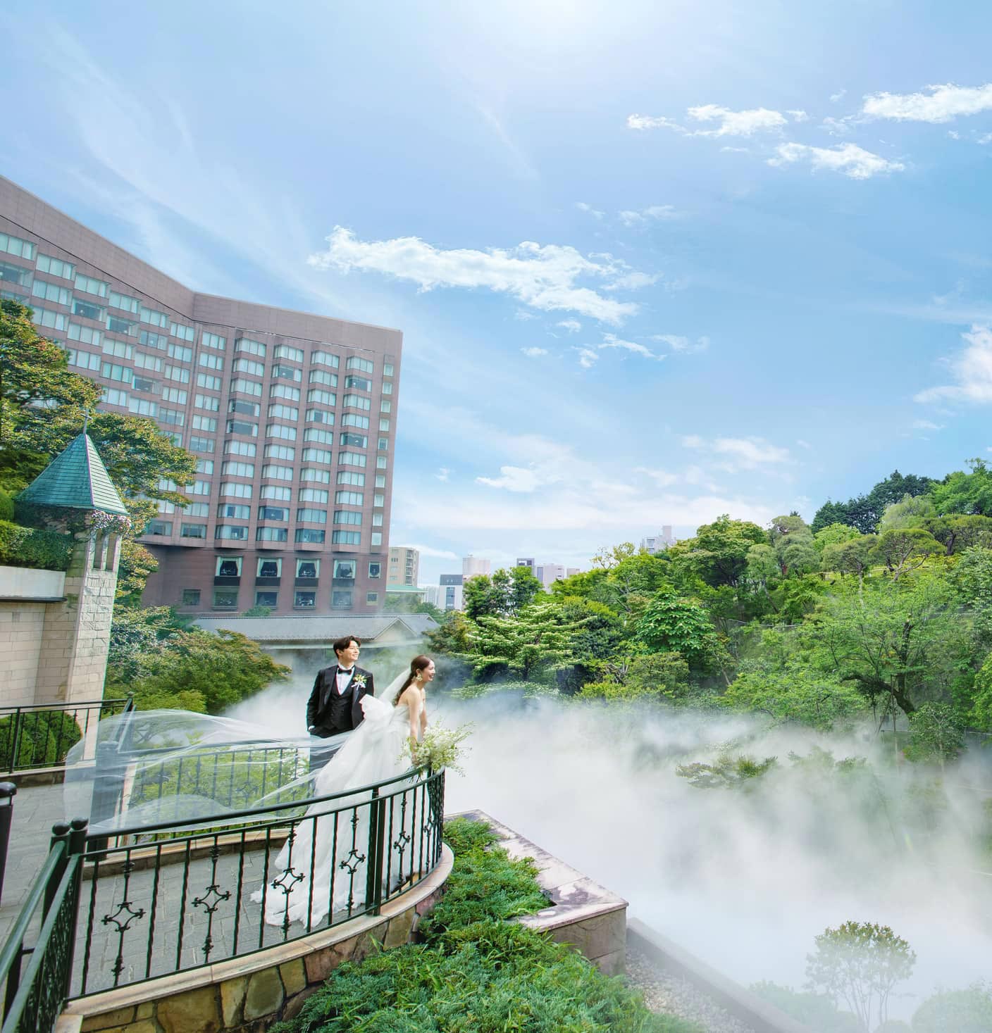 A couple overlooking the historic garden and its mist-covered landscape