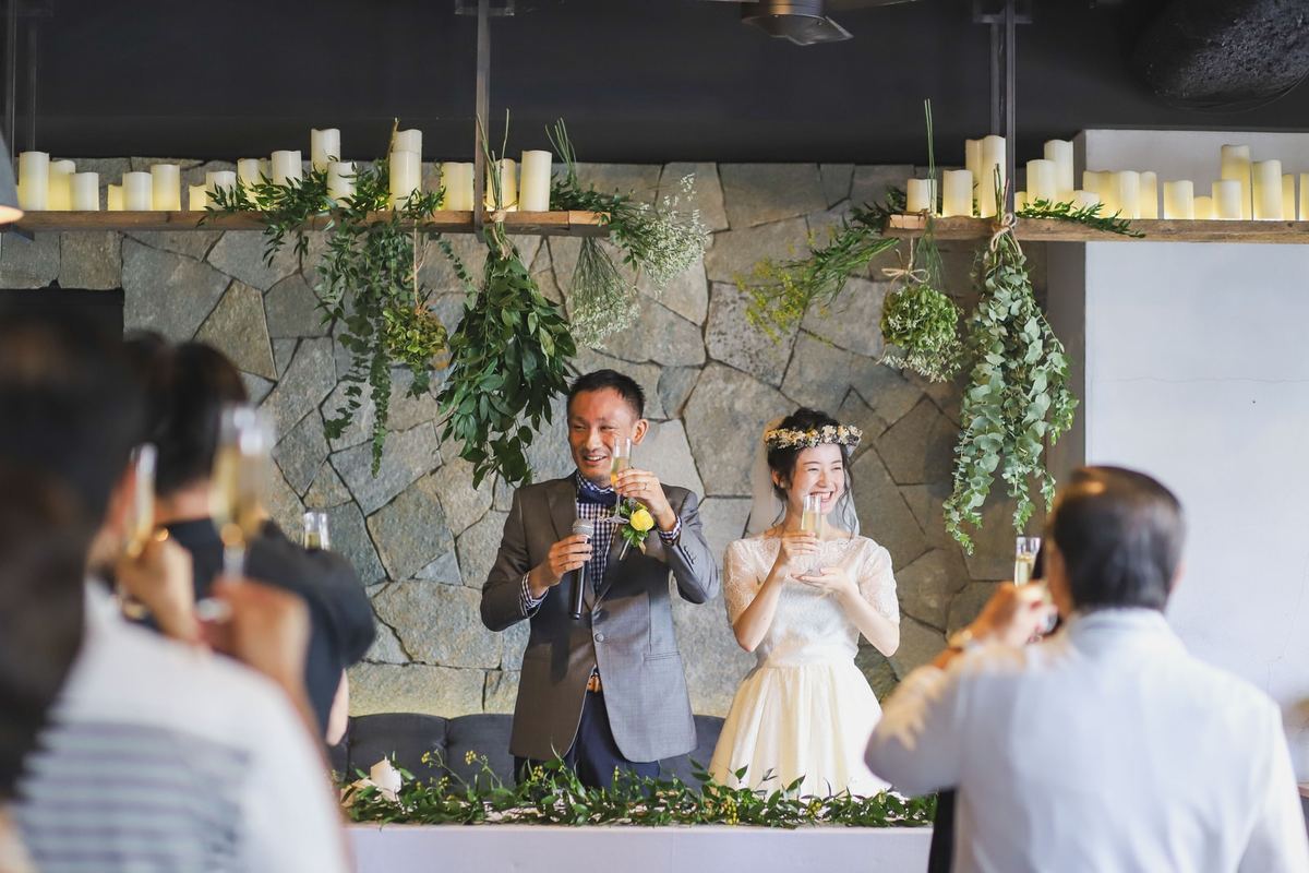 The couple raising a toast during their restaurant reception