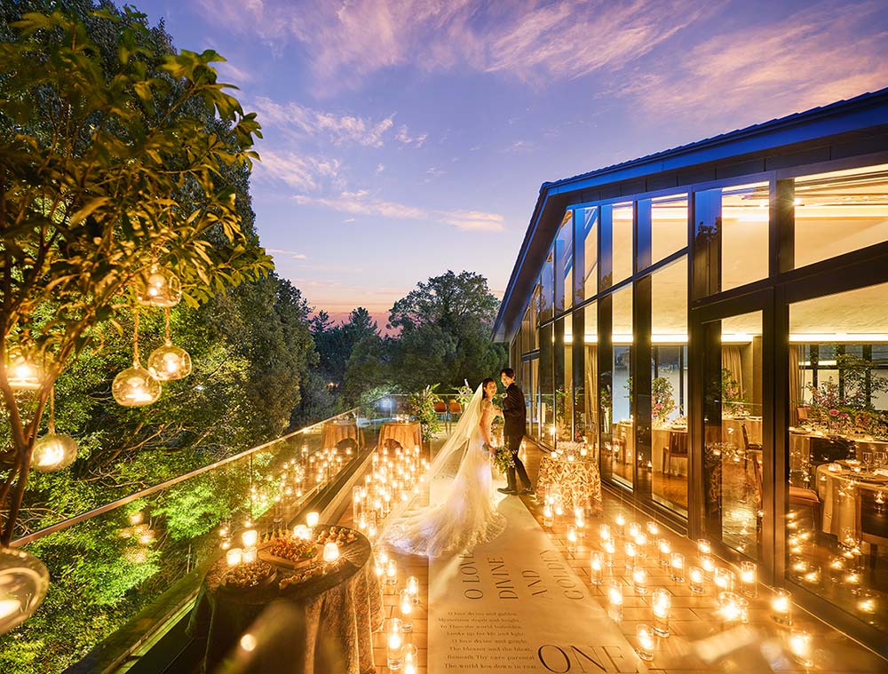 A couple on the candlelit private terrace at sunset