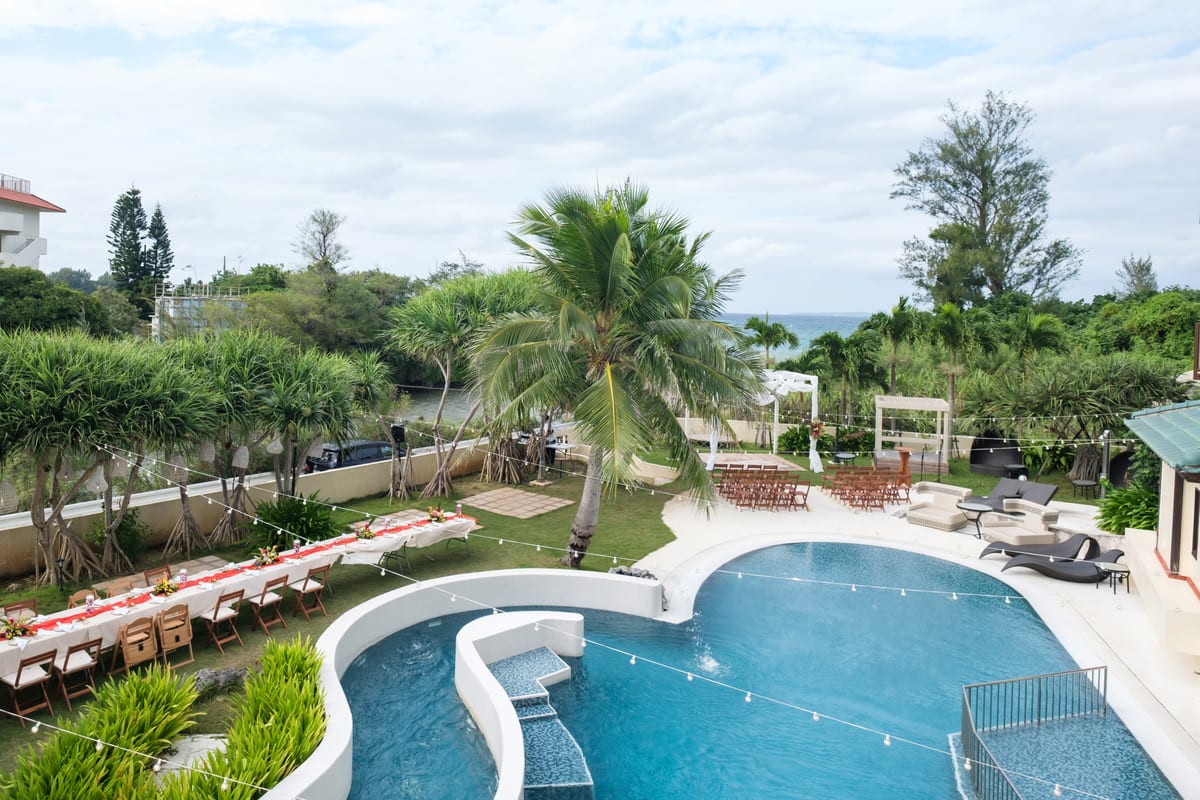 The pool and garden prepared for an outdoor wedding ceremony