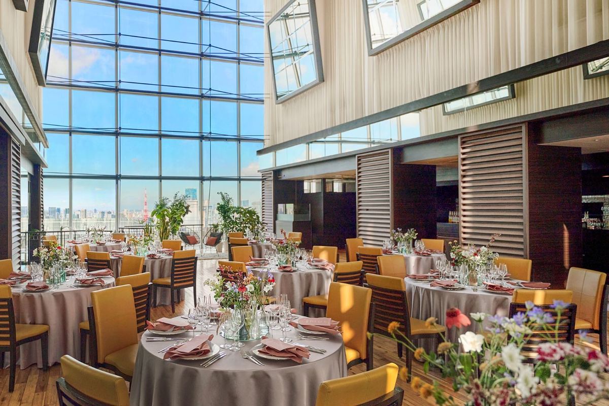 The glass-walled sky lounge prepared for a reception