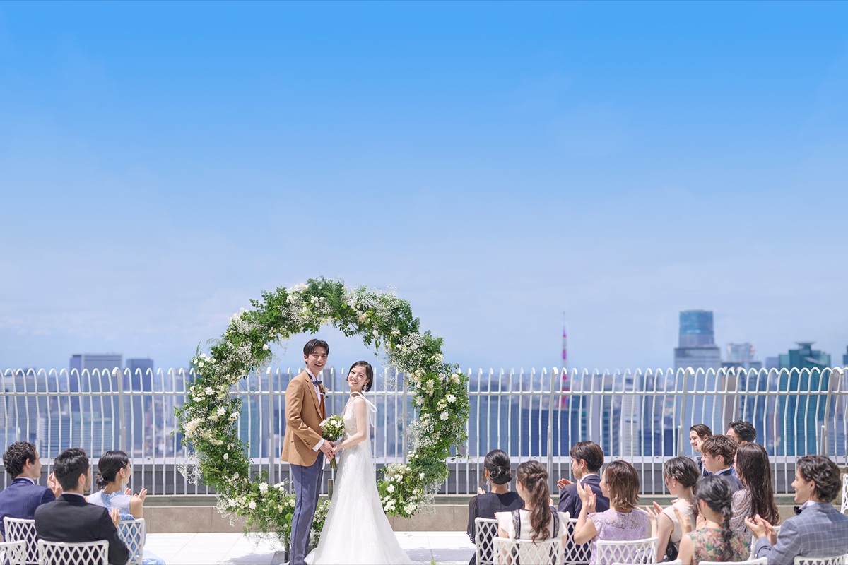 The couple standing in the glass-walled reception room