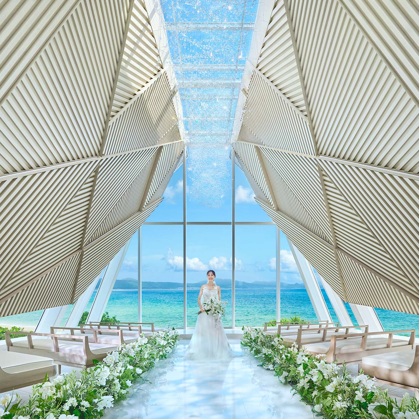 A bride standing inside the ocean-view chapel at THE SURF BEACHSIDE TERRACE